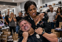 I thought it was just a normal afternoon at the mall until an off-duty man with a badge cornered me, grabbed my backpack strap, and loudly claimed my African American mother could never be a high-ranking military officer. He tried to humiliate me in front of dozens of recording cameras by forcing me to call her. But he had no idea my mom was already walking inside, and the shocking reason he targeted me was about to backfire…