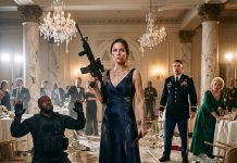 I stood in my torn, blood-stained evening gown, gripping a combat knife and a captured rifle. At my feet, a heavily armed mercenary collapsed on the marble floor. My cowardly husband cowered in absolute terror, finally realizing who he married. But the fight wasn’t over…