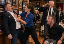 “YOU WERE NEVER ONE OF US,” The Reunion Coordinator Said as He Grabbed My Shoulder—Then a Double-Amputee Veteran Whispered “Doc,” the Old Sergeant Major Rose to Salute Me, and Every Old Soldier Behind Him Began Rising at Once Without a Word