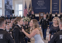 Hundreds of officers watched as my sister grabbed at my uniform and demanded that security remove me for “impersonating someone important.” I stayed perfectly still while the room went silent, knowing she had just crossed a line no apology could erase. Then footsteps echoed down the center aisle, and one voice behind her said, “Take your hands off my commanding officer.”