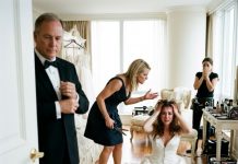 You started it,” my dad muttered while adjusting his cuffs as my sister stood over me with shears, leaving me bleeding in my ruined wedding gown. But they had no idea my hidden camera caught everything—and the massive reception screen was already waiting for them.